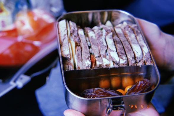 A box full of sandwiches and dates.