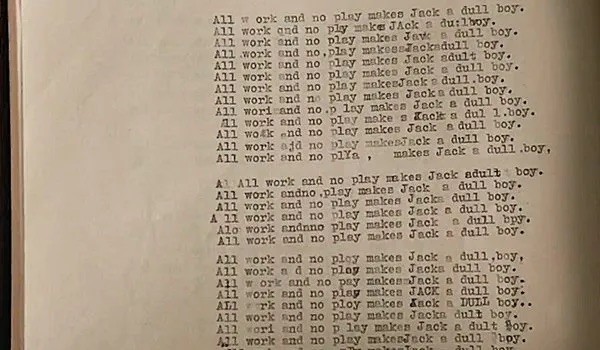 A screenshot of the movie The Shining showing a typed page full of “All work and no play make Jack a dull boy”