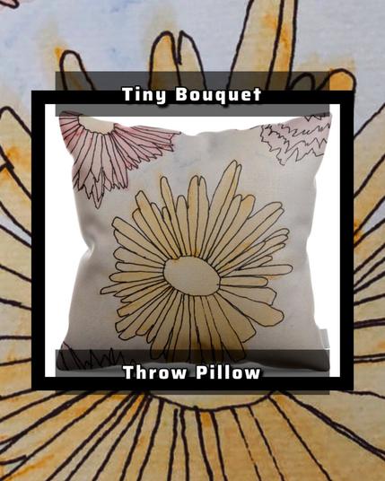 A stunning work of watercolor and ink flowers of various colors surrounded by white. On a throw pillow.