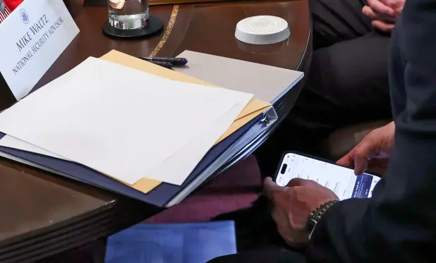 Michael Waltz, who Trump said Thursday will be giving up his role as national security adviser to become the nominee for U.N. ambassador, is seen checking his phone while attending Wednesday's Cabinet meeting at the White House. (Evelyn Hockstein/Reuters)