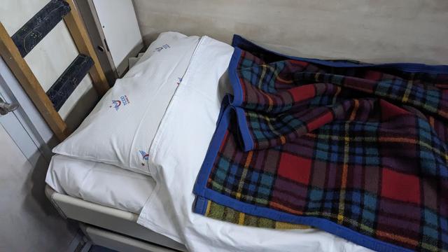 A bed in a night train with TCDD logos.