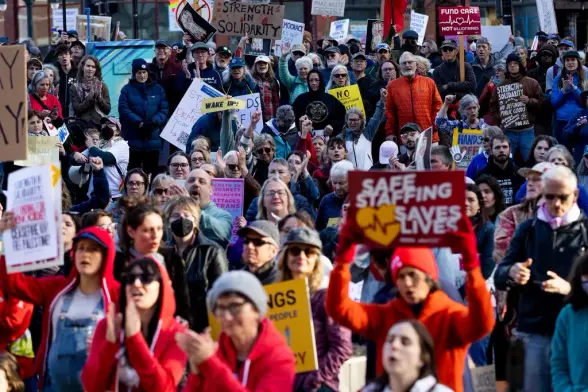 People filling up the street, holding signs.