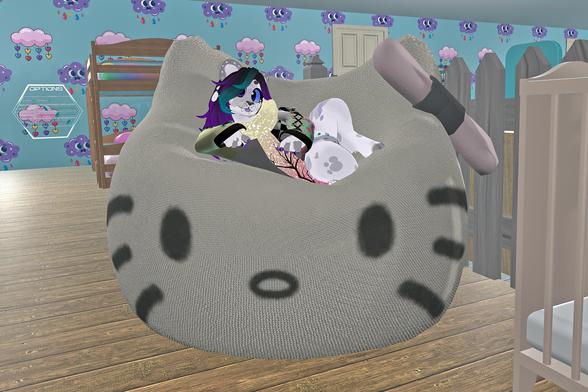 The photo shows an anthropomorphic furry character relaxing in a large, grey beanbag chair shaped like a cat's face. The beanbag is in a child's room with a bunk bed and crib visible in the background.