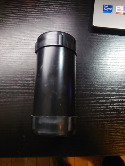 A picture of a black plastic tube with 2 rubber end caps which houses the toolkit.
