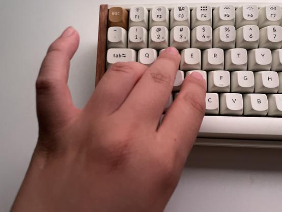 Hand with three fingers resting on the WAS keys. My pinky finger is raised and entirely unused.