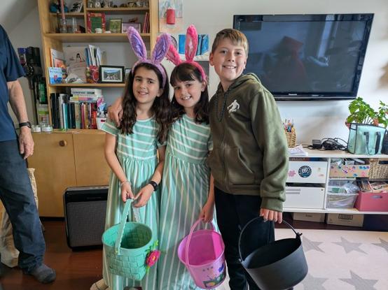3 kids get ready for the easter egg hunt
