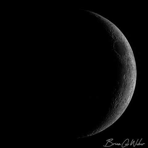 A 15% waxing crescent moon showing heavy shadows around the terminator