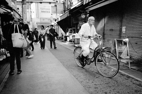 A cyclist on a narrow street