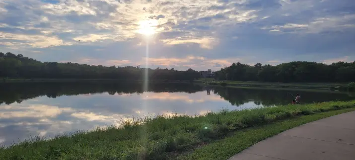 Warm summer day, father and child fishing at the pond