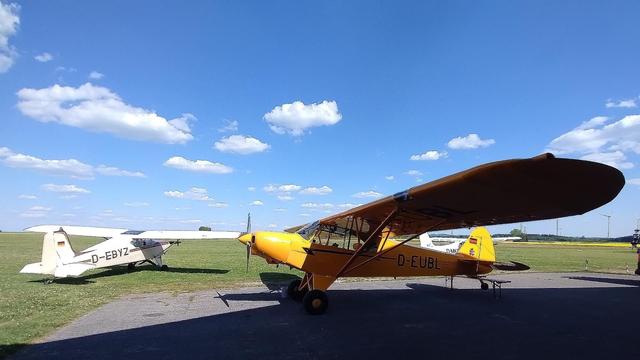 PA18 parked with SF23 to be seen in the background.