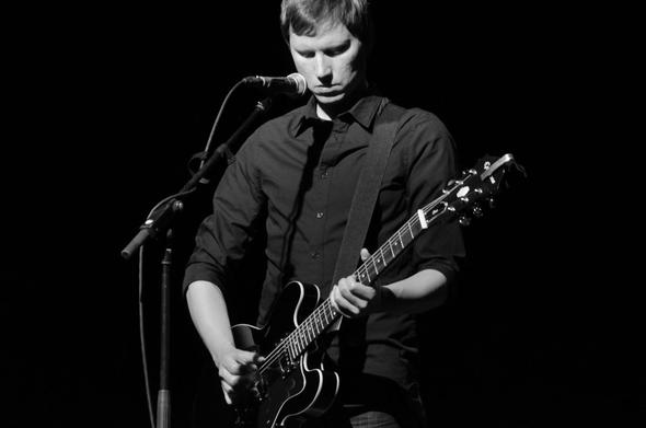 Black and white photo of Nathan Amundson aka Rivulets playing live.