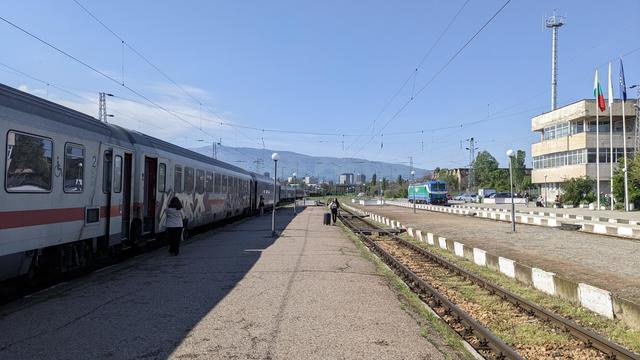 Sofia North station with a Vectron and an RIC train consisting of ex-DB carriages with most carriages still im DB livery.