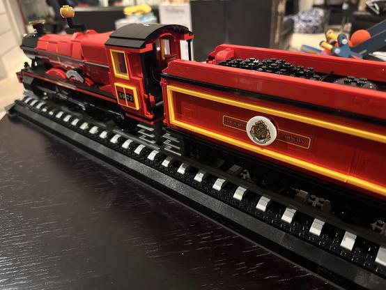 A portion of the Lego Hogwarts Express. Taken from the side, the camera is looking from the coal cart forward to the engine.