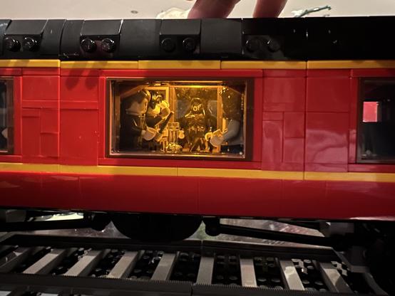 Looking in one of the carriage windows. A button on the roof of the carriage turns on an internal light, illuminating the scene from Harry Potter and the Prisoner of Azkaban when a Dementor attack Harry on the way to Hogwarts.