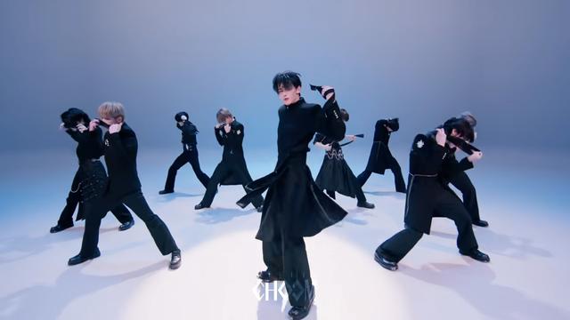 &team performing "Go in Blind" on Studio Choom. Most of the members are in the middle of removing their blindfolds.