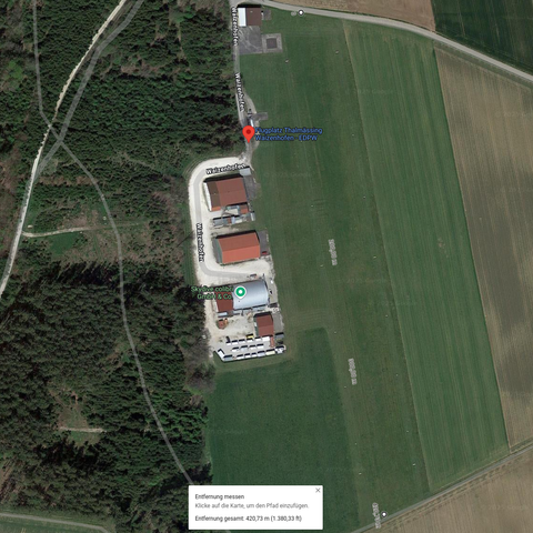 Screenshot of Google satellite view and a measurement showing about 400m when using the strips of grass between runway and road and the field