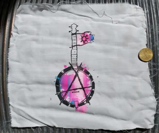 A screenprinted drawing of a banjo. Near the head, there is a small flag with a gender chaos symbol attached. Over the other head, the banjo head, there is an a drawn in such a way to make a circle A together with the instruments' shape.