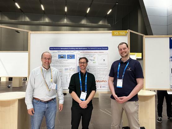 Martin Schön, Andreas Platis and Yann Büchau standing at EGU in front of the PARASITE poster