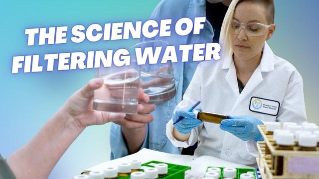 A scientist in a white lab coat from the Orange County Water District examines water samples in test tubes while wearing safety glasses and blue gloves, with the text "THE SCIENCE OF FILTERING WATER" overlaid on a blue background.