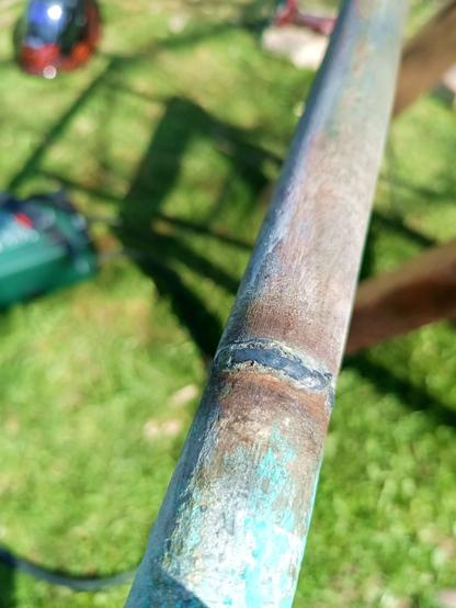 My weld, joining two pieces of galvanized steel pipe to extend them in length. It's not a great seam and unlikely to be watertight, but in comparison to the previous one it looks much better.