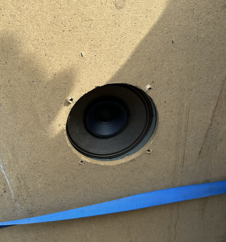 Closeup of a pinball machine's bottom speaker without the grille.