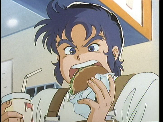 It's Kento in casual clothes - Brown overalls, white tee, and a black hat. Kento is in the process of taking a bite out of a burger held in his left hand, while his right hand keeps a drink close by. He maybe stress eatting a little bit.