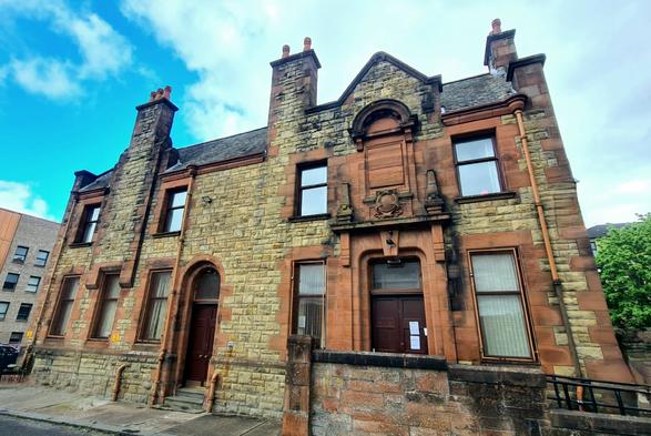 A Victorian hospital building made from a mix of blonde and red sandstone.