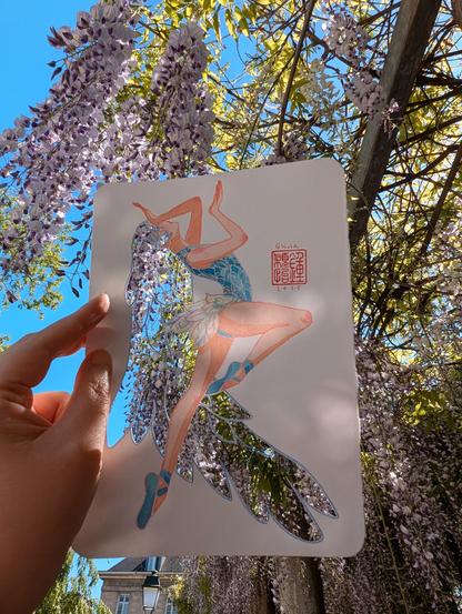Cut out illustration of a ballerina surrounded by blooming wisterias