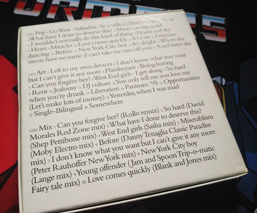 Back of the box, which is entirely taken up by the track listing for the three included CDs in a serif typeface.
