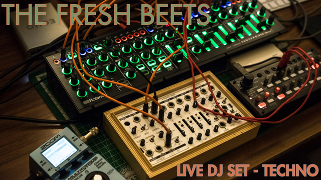 A small modular synthesizer setup, with wires going all over the place.

The top left corner is titled "The Fresh Beets" and the bottom right corner is subtitled "Live DJ Set - Techno".