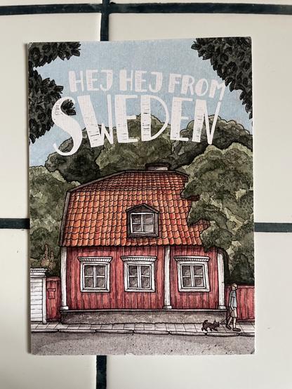 A postcard featuring a rustic-looking building or house with the phrase “Hej Hej from Sweden” in a casual-looking font at the top.