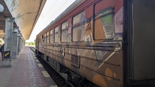 A red BDŽ class 32 full of graffiti.