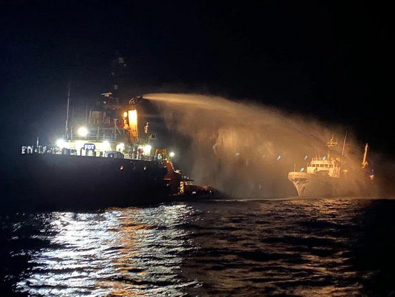 A tug boat assists Freedom Flotilla Coalition vessel Conscience off the coast of Malta.