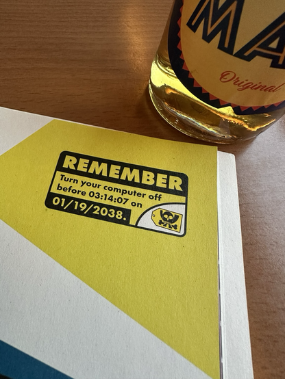 Foto eines Banners in der Hackbibel: „Remember: Turn your computer off before 03:14:07 on 01/19/2038.“