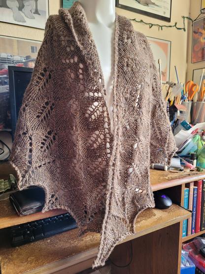 Ashton shawl, done by me, hanging from an armless torso mannequin.