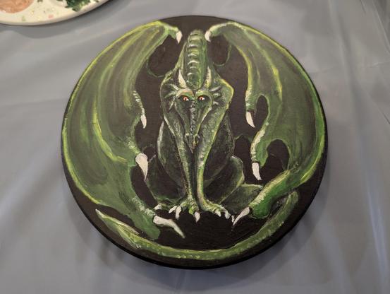Round canvas with a green dragon.