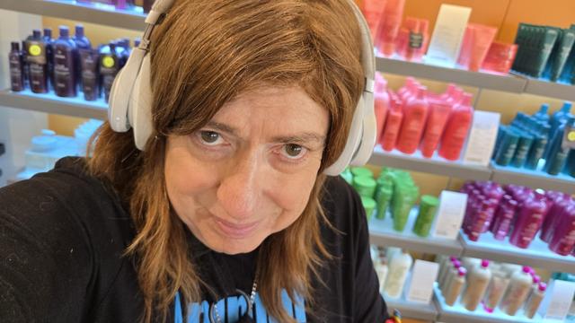 Selfie of me In an elderly white woman with Jace eyes and pastor white skin tone. My hair is posted slightly off center and is cinnamon, shoulder lint