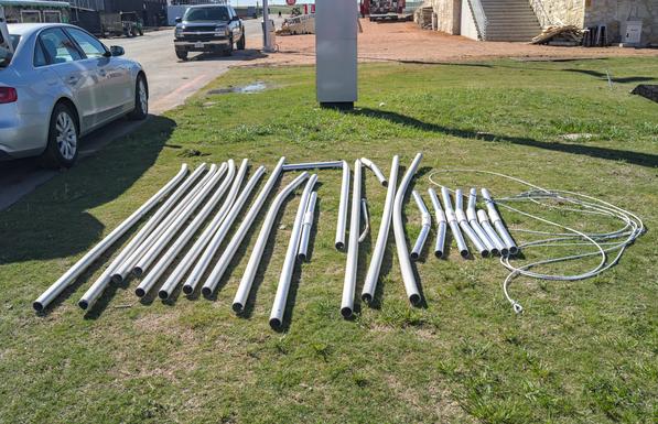The bent poles from the large event tents that were pulled out of the ground by the storm