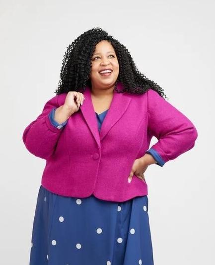 A model in a single breasted pink wool blazer with one button.⁠