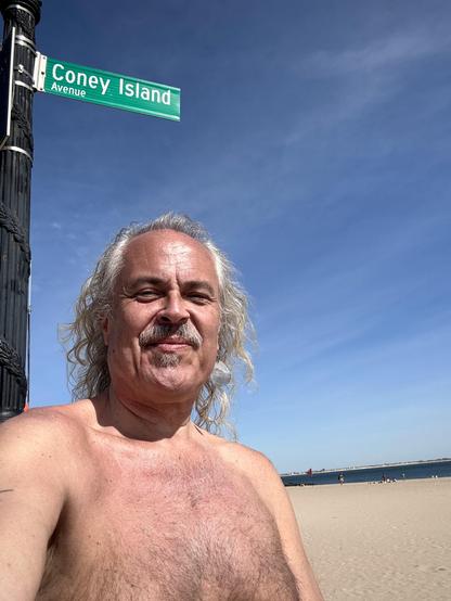 Selfie on Brighton Beach beneath the Coney Island street sign and NYC Parks sign proclaiming it also Neil Sedaka Way.