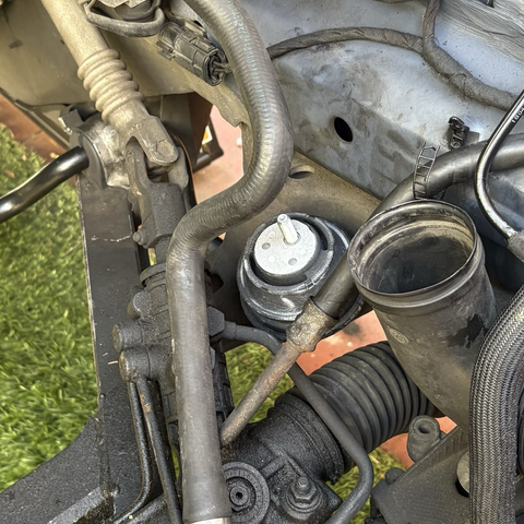 A view into the engine compartment of my 2003 BMW 5-series station wagon, where a new left-hand side motor mount is in place, awaiting installation of the engine.