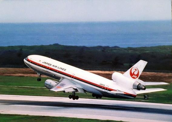 The view is from the right and behind. The plane has just lifted off the runway.
