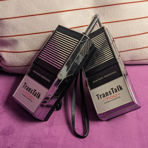 two chrome "TransTalk" walkie talkies