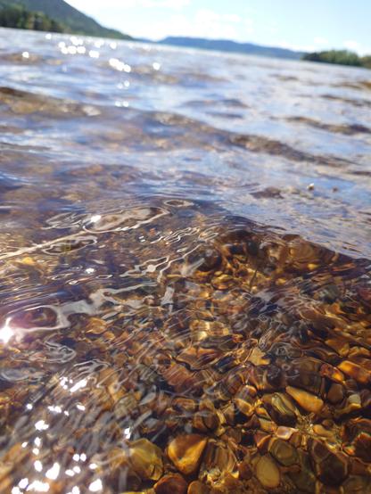 Close up of clear water, you can see the rocks on the bottom