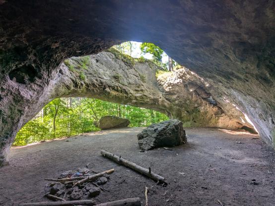 A small cave with a large hole in the roof.