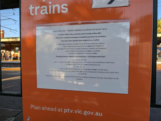 Photo of a "buses replace trains" sign with tiny font and very long wording explaining a train disruption