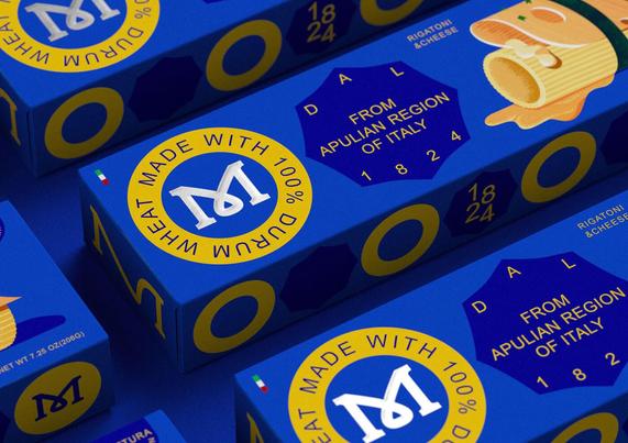 Blue pasta packaging featuring yellow circles and a prominent "M", labeled as made from 100% durum wheat from Apulia, Italy.