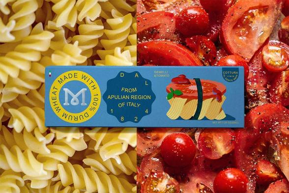 A package of durum wheat pasta rests atop uncooked fusilli and fresh tomatoes, emphasizing an Italian culinary theme.