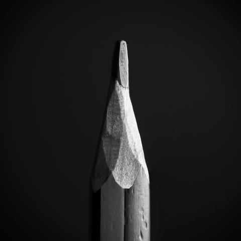 Black and white photo of a knife sharpened pencil.