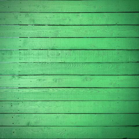 Bright green horizontal fence pickets stack vertically to fill the entire frame.